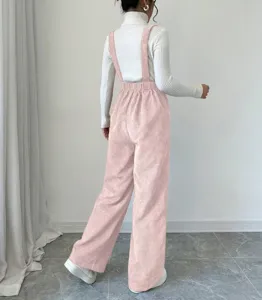 Detailed back view of casual pink corduroy overalls paired with a cozy white sweater.