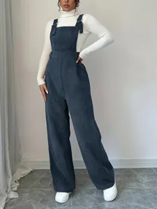 Casual women corduroy overalls loose straight long jumpsuit matched with a white turtleneck top.