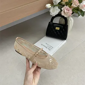 Detail view of beige mesh flat shoes featuring elegant beaded floral embroidery and a sleek strap.