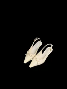 Elegantes zapatos slingback nude de punta fina, con lazo delicado y tacones finos muy chic.