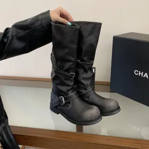 Vintage distressed mid-calf motorcycle boots for women with chunky heels and buckle straps.