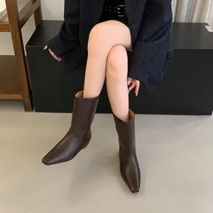 Square toe brown boots detail view, sleek leather finish, stylish mid-calf footwear for women.