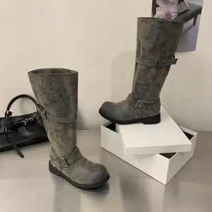 Retro distressed tall motorcycle boots for women with chunky heels, buckles and cargo style.