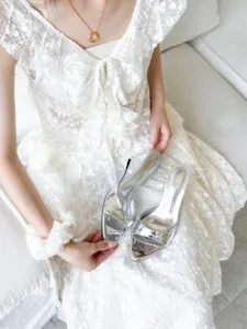 Silver metallic open toe wedge high heels detail shot showcasing elegant French style footwear.