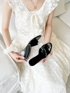 Black patent leather wedge mules, high heel open toe design for stylish summer looks.