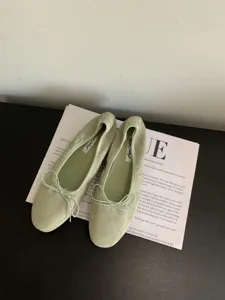 Bailarinas planas de ante verde salvia con lazo delicado, diseño retro chic para mujer.