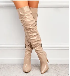 Detailed showcase of glossy patent leather pointed toe stiletto over the knee high boots.
