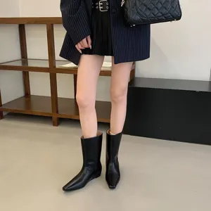 Close-up of stylish black square toe short boots featuring a modern slip-on wedge design.