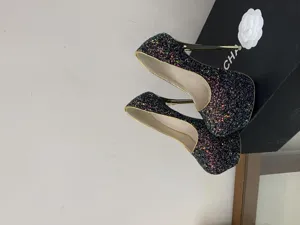 Glitter platform stiletto high heels detail, sparkling sequin design with gold trim finish.