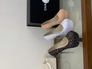 Glitter platform high heels detailed view, featuring sparkling sequins and stiletto heels.