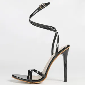 Black patent leather strappy high heel sandal detail view, elegant stiletto heel evening party shoe.