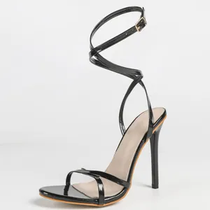 Detailed view of the elegant black patent strappy high heel sandal with cross straps.