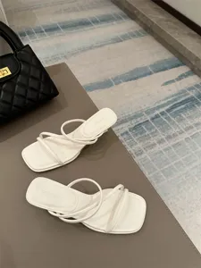 Κομψά λευκά mules πέδιλα με τετραγωνισμένη μύτη, λεπτά λουράκια και τακούνι kitten για γυναίκες.