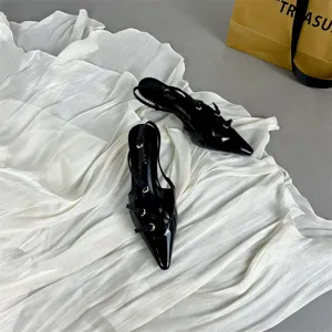 Chic black patent leather pointed toe slingbacks with stylish straps and kitten heels.