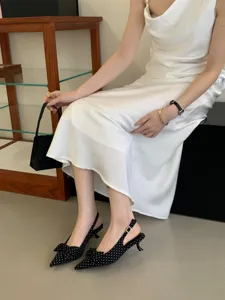 Chic pointed toe slingback kitten heels with classic polka dot pattern and cute bow detail.