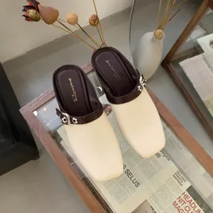 Close-up detail of retro square toe two-tone Mary Jane low heel mules shoes elegant style.