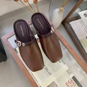 Retro square toe leather mules detail showcasing elegant brown tone and delicate floral buckle accent.