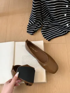 Detail view of brown flat Mary Jane shoes featuring soft sole, elegant and comfortable daily wear.