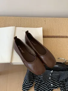 Detail view of brown retro flat shoes, soft leather material, elegant daily casual footwear choice.