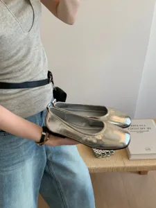 Silver metallic flat shoes detail view, showcasing soft sole and vintage French style.