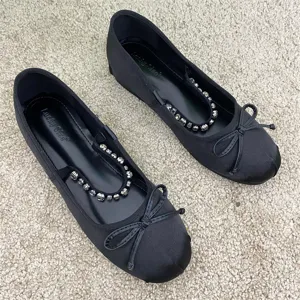 Scarpe basse Mary Jane in raso nero da donna con cinturino di cristalli e fiocco.