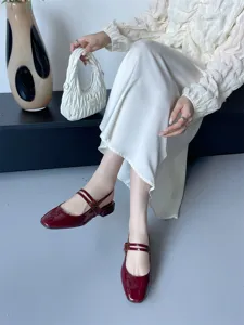 Détail rapproché des chaussures slingback à bout carré en cuir vernis rouge et brides.