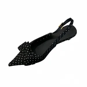 Elegant black polka dot pointed toe slingback flat shoes featuring a cute bow detail for women.