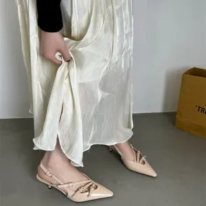 Beige patent leather slingback kitten heels with multi straps and pointed toe design for women.