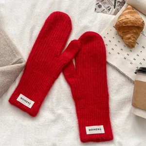 Red winter knitted warm gloves detail, soft wool mittens for women daily cold weather.