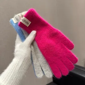 Detailaufnahme bunter, kuscheliger Kaninchenfell-Winterhandschuhe, weiche Strickwarenpräsentation.