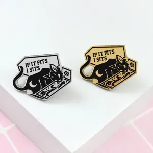 Detailed close-up of cute black cat enamel lapel pins in silver and gold metal designs.