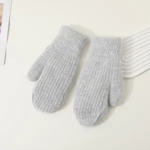 Detailed view of winter thick warm grey knitted mittens, soft woolen material for cold weather.