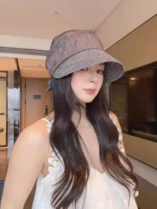 Detailed view of women's straw patchwork bucket hat, summer sun protection sunhat, casual style.