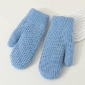 Detailed view of winter thick warm knit mittens in light blue, soft cozy thermal cold weather gear.