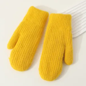 Winter thick warm knitted mittens, bright yellow color detail, soft thermal gloves.