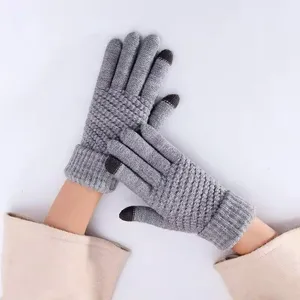Grey knitted touch screen gloves detail view, warm winter knitwear close up display.