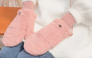Close-up detail of winter plush mittens with knit cuffs and cozy pink faux fur design.