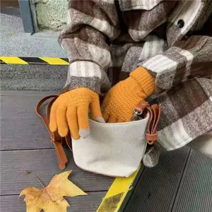 Orange knitted touchscreen gloves for winter warm outdoor use, flexible five finger design.