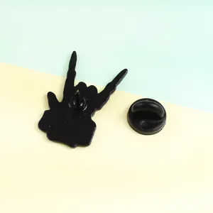 Punk rock gesture metal brooch back view detail showing secure pin and black rubber clutch cap.