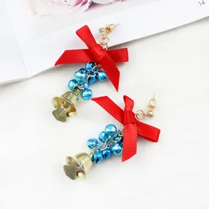 Christmas bow bell earrings detail, featuring red ribbon and blue bells for festive style.