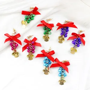 Christmas bow bell earrings detail display, featuring colorful small bells and gold pendants.