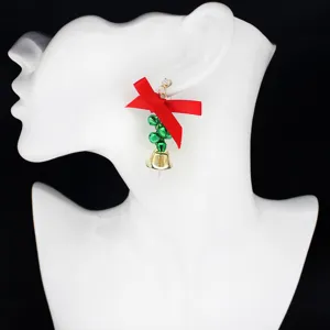 Christmas bow bell earrings, festive red ribbon and gold bell pendant jewelry for women.