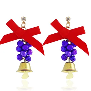 Christmas dangling earrings featuring red bows, purple bell clusters, and gold pendants.