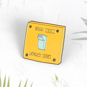 Detailed view of creative switch enamel pin, yellow and blue lapel badge, cute clothing accessory.