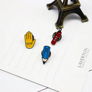 Cute cartoon enamel pins set featuring stop hand, blue pencil, and red TNT dynamite brooches.