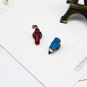 Close-up detail of creative cartoon pencil and dynamite enamel pins, stylish metal badge decor.