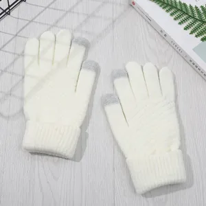 Detail view of white knitted winter gloves with touch screen fingertips for warm daily use.