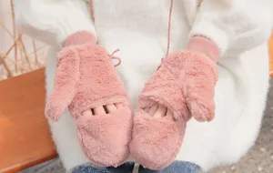 Close-up of cozy winter plush gloves, fluffy pink convertible fleece mittens style.
