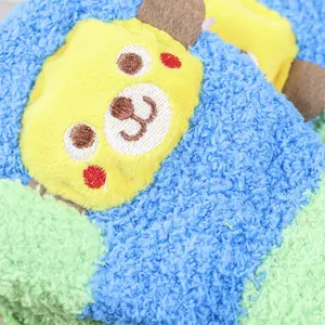 Detailed close-up of cute cartoon bear kids coral fleece gloves, soft warm winter fabric.