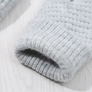 Grey knitted glove detail close up, soft warm winter thermal ribbed cuff texture display